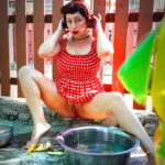 Retro maid prepares potatoes for dinner. Vintage performance
